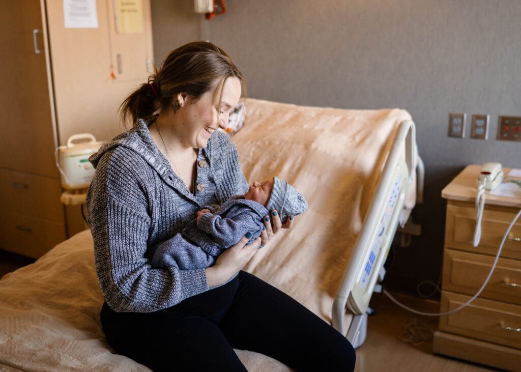 New Mom holding baby during Spokane Newborn Photography session
